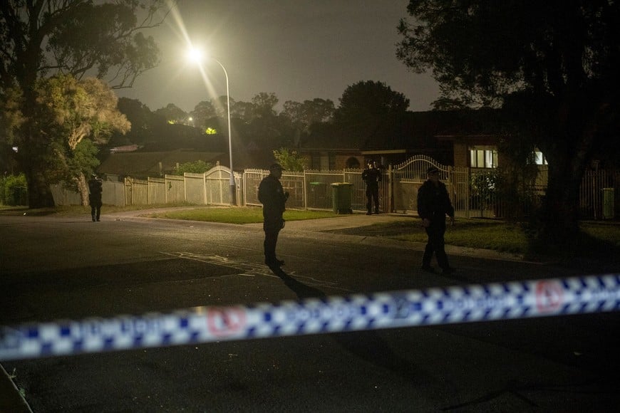 A police crime scene has been established at the home of a suspect in Bonnyrigg, following a deadly shooting at Bondi Beach, in Sydney, Australia, December 14, 2025. AAP/Jeremy Piper/via REUTERS ATTENTION EDITORS - THIS IMAGE WAS PROVIDED BY A THIRD PARTY. NO RESALES. NO ARCHIVE. AUSTRALIA OUT. NEW ZEALAND OUT. NO COMMERCIAL OR EDITORIAL SALES IN NEW ZEALAND. NO COMMERCIAL OR EDITORIAL SALES IN AUSTRALIA.