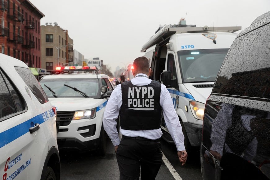 A police officer works near the scene of a shooting at a subway station in the Brooklyn borough of New York City, New York, U.S., April 12, 2022. REUTERS/Brendan McDermid