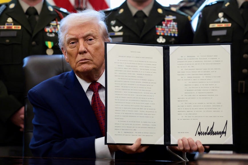 U.S. President Donald Trump shows a signed executive order classifying fentanyl as 'weapon of mass destruction' during a Mexican Border Defense Medal presentation in the Oval Office at the White House in Washington, D.C., U.S., December 15, 2025. REUTERS/Evelyn Hockstein