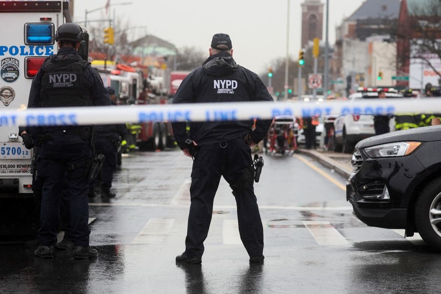 Police officers work near the scene of a shooting at a subway station in the Brooklyn borough of New York City, New York, U.S., April 12, 2022. REUTERS/Brendan McDermid
