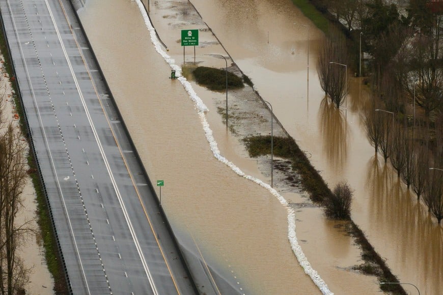 A drone view shows floodwaters on a closed highway in an area flooded by the Green River, after multiple atmospheric rivers brought rain and flooding to the Pacific Northwest, in Kent, Washington, U.S., December 15, 2025.  REUTERS/David Ryder