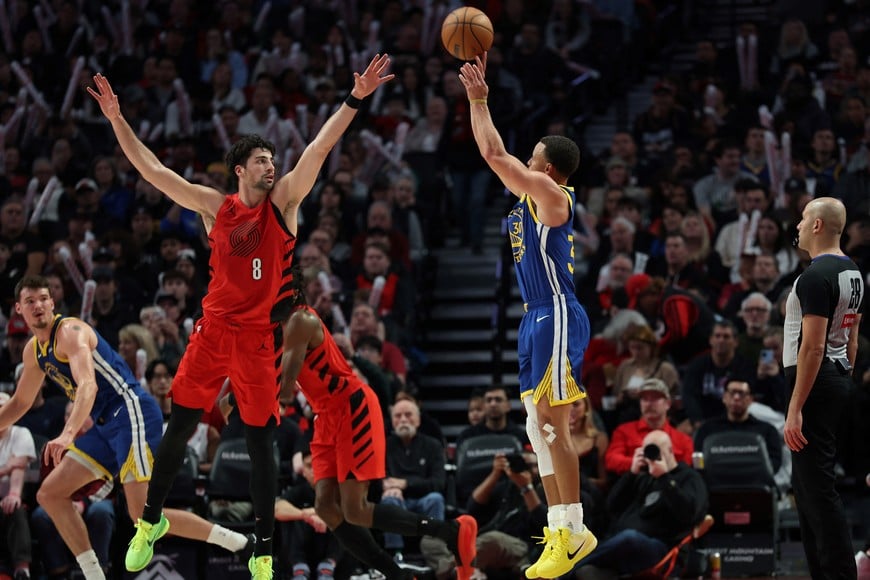 Dec 14, 2025; Portland, Oregon, USA; Golden State Warriors guard Stephen Curry (30) shoots the ball over Portland Trail Blazers forward Deni Avdija (8) during the second half at Moda Center. Mandatory Credit: Jaime Valdez-Imagn Images