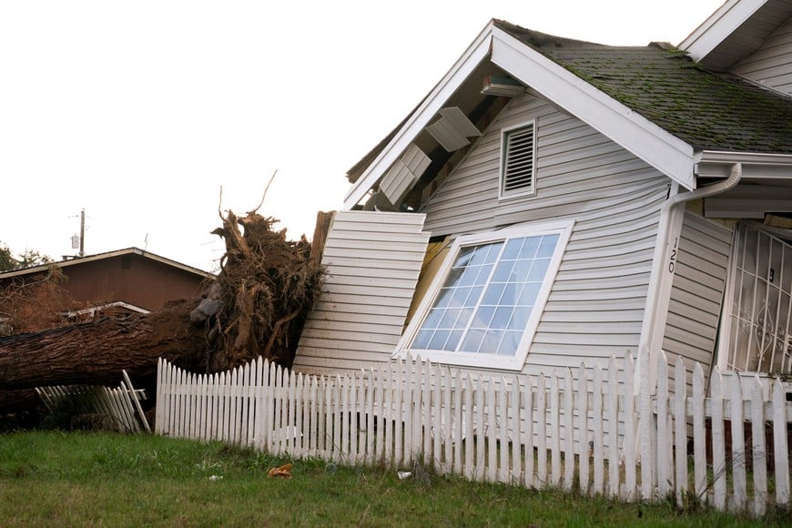 Damage to a home after winds knocked down a tree, as extreme weather continues to batter the Pacific Northwest, in Tacoma, Washington, U.S., December 17, 2025.  REUTERS/David Ryder