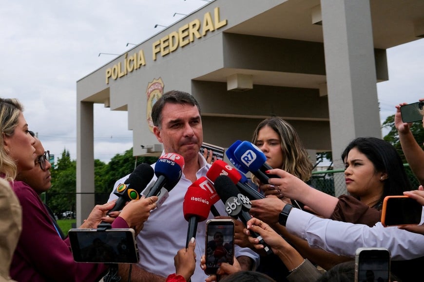 FILE PHOTO: Senator Flavio Bolsonaro, Brazil's former President Jair Bolsonaro's son, speaks to the media after visiting his father at a Federal Police building in Brasilia, Brazil, December 16, 2025. REUTERS/Diego Herculano/File Photo