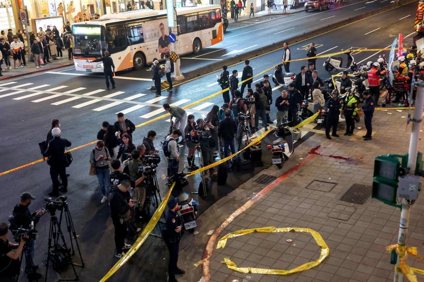 Media members stand outside Eslite Spectrum Nanxi store near Zhongshan station as the entrance of the building is cordoned off with yellow crime scene tape, following an incident in which several were injured after a person released smoke bombs and attacked bystanders, according to the government and local media, in Taipei, Taiwan, December 19, 2025. REUTERS/Ann Wang     TPX IMAGES OF THE DAY