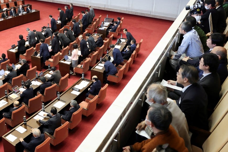 Niigata Prefectural Assembly lawmakers stand up from their seats to show their confidence in Niigata Prefecture Governor Hideyo Hanazumi's decisions on a partial restart of the Tokyo Electric Power Company's (TEPCO) Kashiwazaki Kariwa Nuclear Power Plant, one of the world's largest nuclear power plants and which was among the reactors shut after a massive earthquake and tsunami in 2011 crippled TEPCO's Fukushima Daiichi plant, in Niigata, Japan December 22, 2025.  REUTERS/Issei Kato