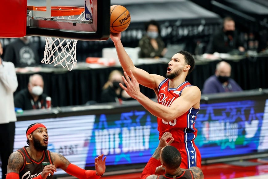 Feb 11, 2021; Portland, Oregon, USA; Philadelphia 76ers point guard Ben Simmons (top) shoots the ball against Portland Trail Blazers point guard Damian Lillard (bottom) during the second half at Moda Center. Mandatory Credit: Soobum Im-USA TODAY Sports