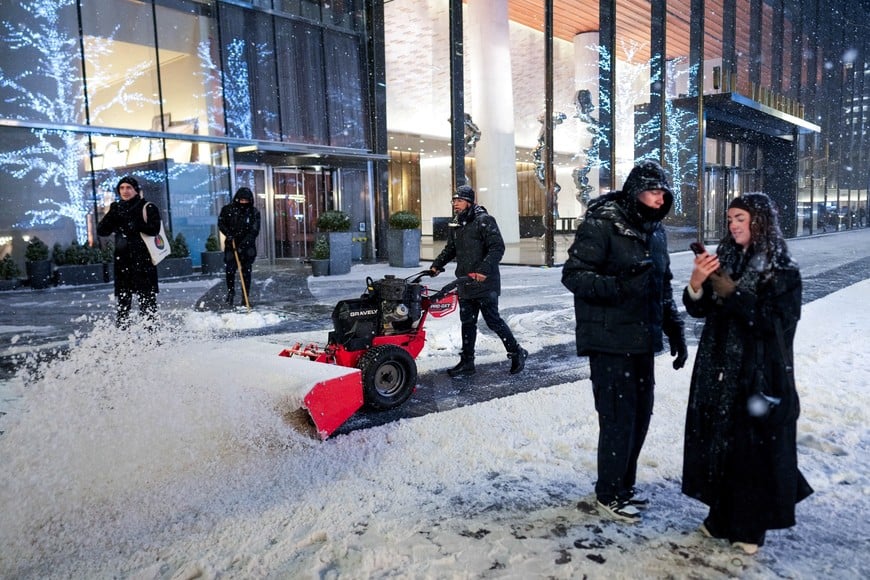 A person plows snow during a winter storm in New York City, U.S., December 26, 2025. REUTERS/Adam Gray