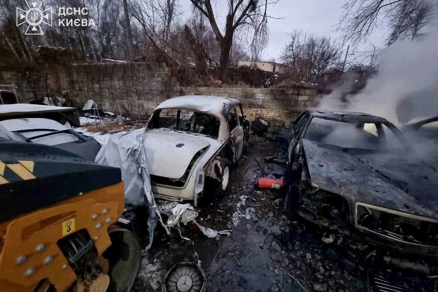 Smoke rises from a burnt car at the site of a repair workshop damaged during Russian missile and drone strikes, amid Russia's attack on Ukraine, in Kyiv, Ukraine December 27, 2025. Press service of the State Emergency Service of Ukraine/Handout via REUTERS ATTENTION EDITORS - THIS IMAGE HAS BEEN SUPPLIED BY A THIRD PARTY. DO NOT OBSCURE LOGO.     TPX IMAGES OF THE DAY