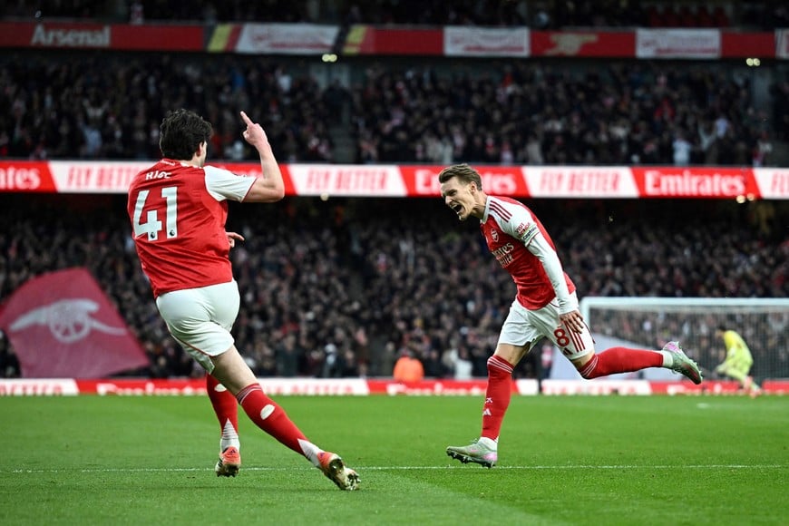 Soccer Football - Premier League - Arsenal v Brighton & Hove Albion - Emirates Stadium, London, Britain - December 27, 2025
Arsenal's Martin Odegaard celebrates scoring their first goal with Declan Rice REUTERS/Dylan Martinez EDITORIAL USE ONLY. NO USE WITH UNAUTHORIZED AUDIO, VIDEO, DATA, FIXTURE LISTS, CLUB/LEAGUE LOGOS OR 'LIVE' SERVICES. ONLINE IN-MATCH USE LIMITED TO 120 IMAGES, NO VIDEO EMULATION. NO USE IN BETTING, GAMES OR SINGLE CLUB/LEAGUE/PLAYER PUBLICATIONS. PLEASE CONTACT YOUR ACCOUNT REPRESENTATIVE FOR FURTHER DETAILS..     TPX IMAGES OF THE DAY