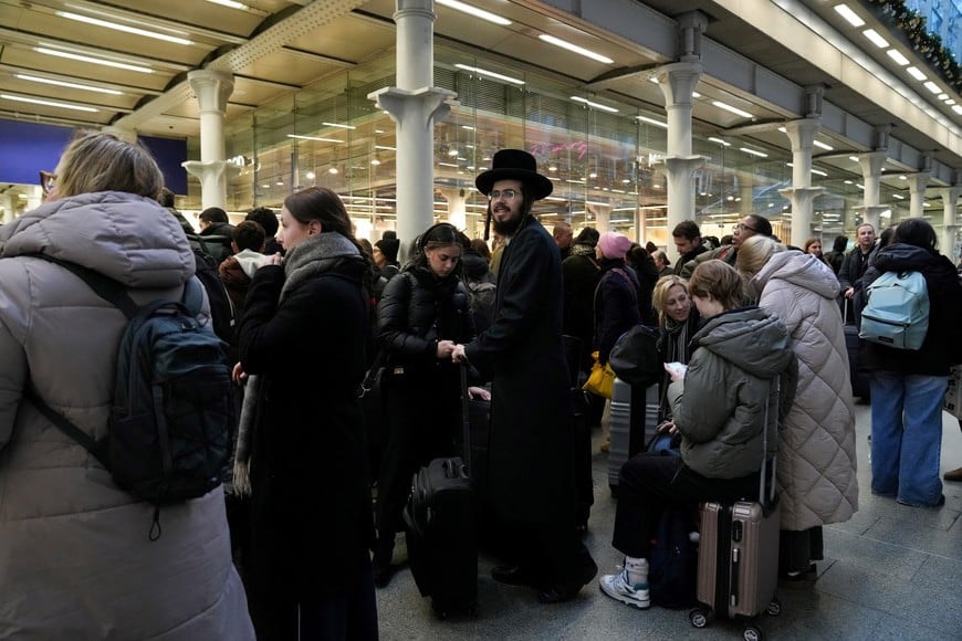 Passengers wait with luggage, after a Eurostar spokesperson said they were suspending its cross-Channel train services to and from London until further notice following a power supply problem in the Channel Tunnel that links Britain and France, at St. Pancras International station in London, Britain, December 30, 2025. REUTERS/Maja Smiejkowska