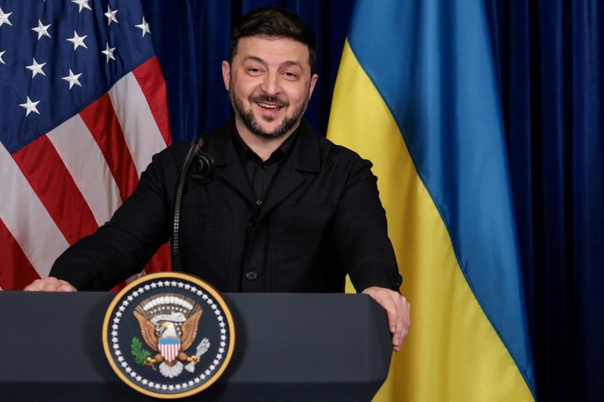 Ukrainian President Volodymyr Zelenskiy smiles after U.S. President Donald Trump said that Russian President Vladimir Putin expressed willingness to help Ukraine "succeed", during a press conference at Trump's Mar-a-Lago club, in Palm Beach, Florida, U.S., December 28, 2025. REUTERS/Jonathan Ernst