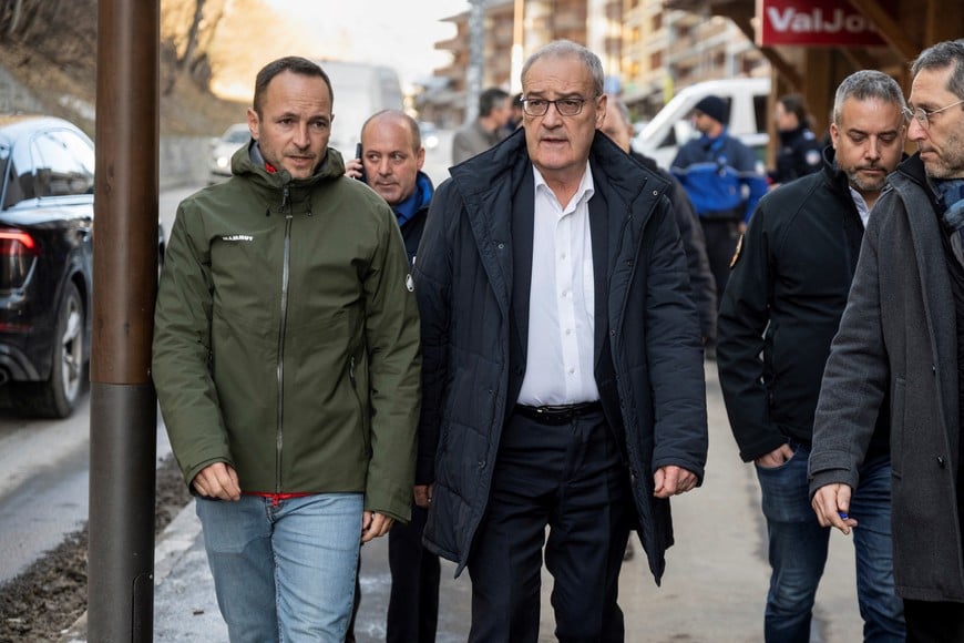 Swiss Federal President Guy Parmelin, and Mathias Reynard, State Councillor and president of the Council of State of the Canton of Valais walks on the day they inspect the area where a fire of unidentified origin broke out at the "Le Constellation" bar and lounge leaving people dead and injured, during New Year’s celebration, in Crans-Montana, Switzerland, on Thursday, January 1, 2026.  ALESSANDRO DELLA VALLE/Pool via REUTERS