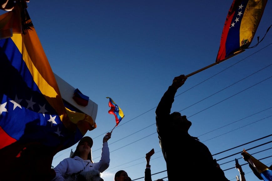People holding Venezuelan flags react to the news after U.S. President Donald Trump said the U.S. has struck Venezuela and captured its President Nicolas Maduro, in Doral, Miami, Florida, U.S., January 3, 2026. REUTERS/Marco Bello     TPX IMAGES OF THE DAY