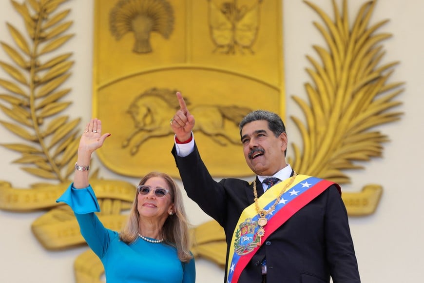 Venezuela's President Nicolas Maduro and his wife Cilia Flores gesture on the day of his inauguration for a third six-year term, in Caracas, Venezuela January 10, 2025. Marcelo Garcia/Miraflores Palace/Handout via REUTERS ATTENTION EDITORS - THIS IMAGE HAS BEEN SUPPLIED BY A THIRD PARTY
