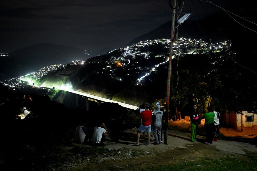 Residents stand outside their homes in the Gramoven neighborhood, as U.S. President Donald Trump said on Saturday the U.S. has struck Venezuela and captured its President Nicolas Maduro, in Caracas, Venezuela January 3, 2026. REUTERS/Maxwell Briceno