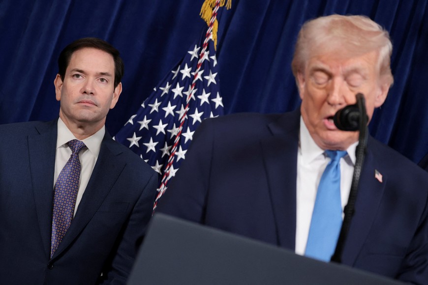 U.S. President Donald Trump speaks as Secretary of State Marco Rubio looks on during a press conference following a U.S. strike on Venezuela where President Nicolas Maduro and his wife, Cilia Flores, were captured, from Trump's Mar-a-Lago club in Palm Beach, Florida, U.S., January 3, 2026. REUTERS/Jonathan Ernst