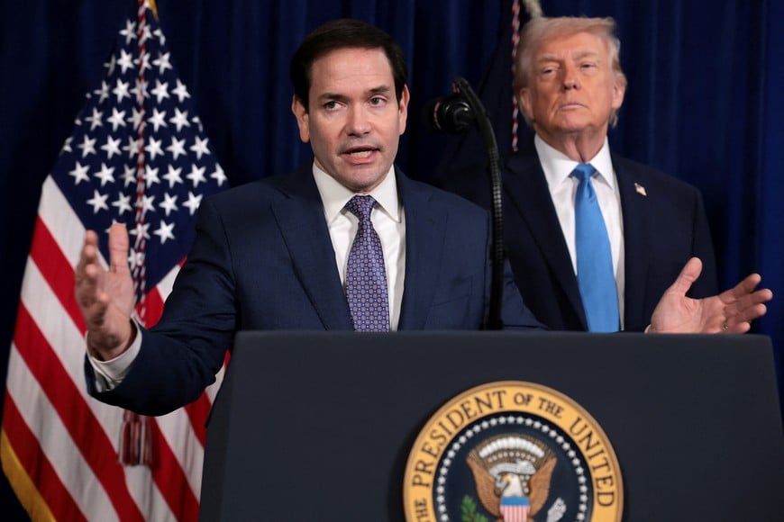 U.S. Secretary of State Marco Rubio speaks as U.S. President Donald Trump stands behind him during a press conference following a U.S. strike on Venezuela where President Nicolas Maduro and his wife, Cilia Flores, were captured, from Trump's Mar-a-Lago club in Palm Beach, Florida, U.S., January 3, 2026. REUTERS/Jonathan Ernst