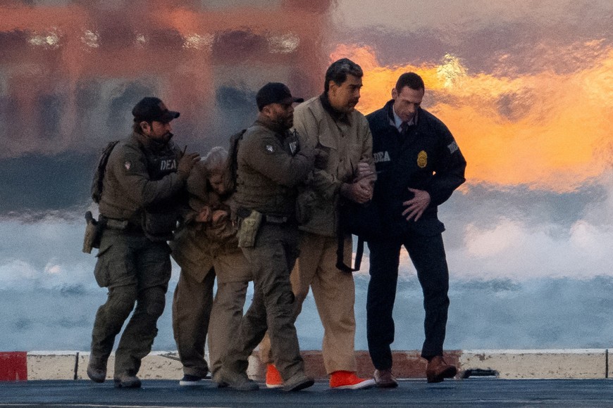 Captured Venezuelan President Nicolas Maduro and his wife Cilia Flores are escorted, as they heads towards the Daniel Patrick Moynihan United States Courthouse in Manhattan for an initial appearance to face U.S. federal charges including narco-terrorism, conspiracy, drug trafficking, money laundering and others, at Downtown Manhattan Heliport, in New York City, U.S., January 5, 2026. REUTERS/Adam Gray