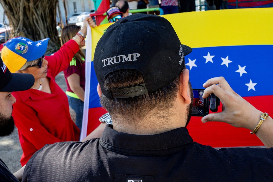 A person uses a phone to film as people react on the streets of San Juan, after the U.S. launched an attack on Venezuela, capturing its president, Nicolas Maduro, and his wife, Cilia Flores, Puerto Rico, January 4, 2026. REUTERS/Eva Marie Uzcategui