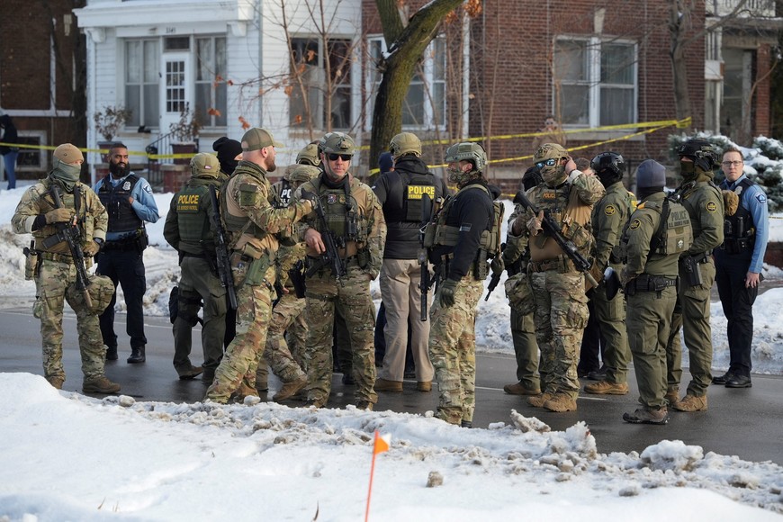 Members of U.S. Immigration and Customs Enforcement (ICE) gather at the scene where a driver was shot by a U.S. immigration agent, according to local and federal officials, in Minneapolis, Minnesota, U.S., January 7, 2026. REUTERS/Tim Evans