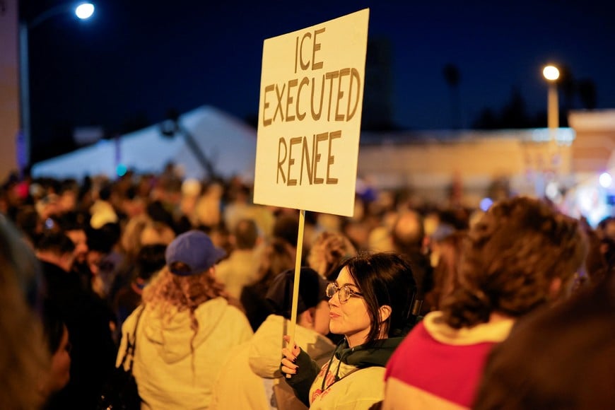 A person holds a sign following the death of Renee Nicole Good, a 37-year-old woman who was shot in her car by a U.S. immigration agent, according to local and federal officials, in Minneapolis, as Altadena community members gather at an event marking the first anniversary of the devastating Eaton Fire, in Altadena, California, U.S., January 7, 2026. REUTERS/Mike Blake