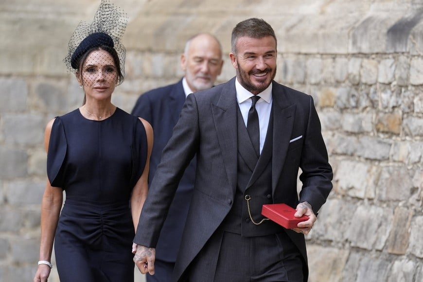 Sir David Beckham, walks with his wife Lady Victoria, after he was made a Knight Bachelor at an investiture ceremony at Windsor Castle, Berkshire. November 4, 2025. Andrew Matthews/Pool via REUTERS