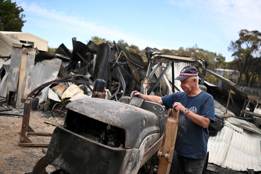 Harcourt CFA first lieutenant Tyrone Rice inspects damage to his property, amid bushfires in Harcourt, Victoria, Australia, January 10, 2026.     AAP/James Ross via REUTERS    ATTENTION EDITORS - THIS IMAGE WAS PROVIDED BY A THIRD PARTY. NO RESALES. NO ARCHIVE. AUSTRALIA OUT. NEW ZEALAND OUT. NO COMMERCIAL OR EDITORIAL SALES IN NEW ZEALAND. NO COMMERCIAL OR EDITORIAL SALES IN AUSTRALIA.     TPX IMAGES OF THE DAY