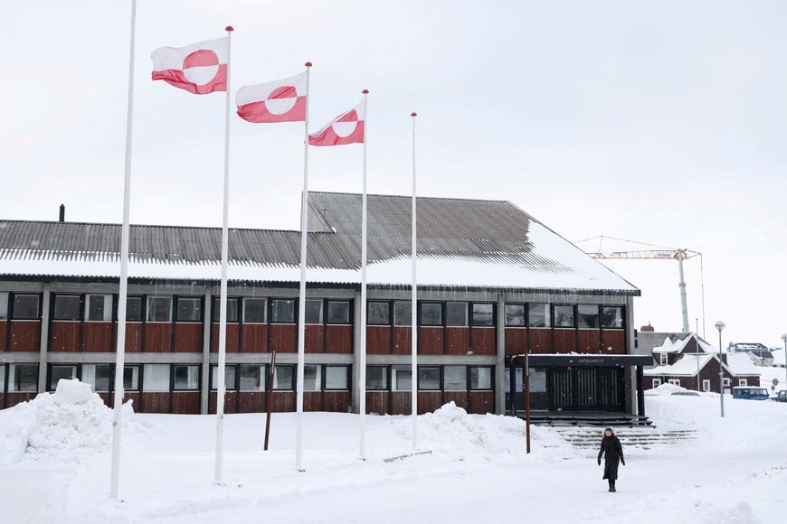 FILE PHOTO: A woman walks past Greenland's parliament Inatsisartut in Nuuk, Greenland, March 28, 2025. REUTERS/Leonhard Foeger/File Photo