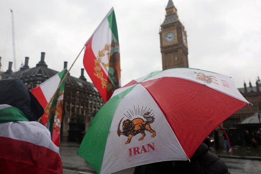 A person holds a "Lion and Sun" pre-Iranian Revolution national flag design umbrella as protesters gather outside the Houses of Parliament in support of nationwide protests in Iran, in London, Britain, January 13, 2026. REUTERS/Toby Melville

     TPX IMAGES OF THE DAY