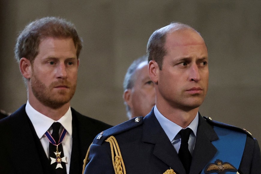 FILE PHOTO: Britain's William, Prince of Wales, and Prince Harry react as the coffin of Britain's Queen Elizabeth arrives at Westminster Hall from Buckingham Palace for her lying in state, in London, Britain, September 14, 2022.  REUTERS/Alkis Konstantinidis/Pool/File Photo