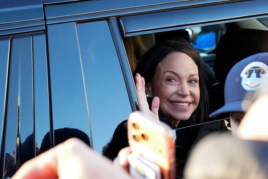 Venezuelan opposition leader Maria Corina Machado waves from a vehicle as she leaves the U.S. Capitol after a meeting with U.S. senators, following an earlier meeting with U.S. President Donald Trump at the White House, in Washington, D.C., U.S., January 15, 2026. REUTERS/Elizabeth Frantz