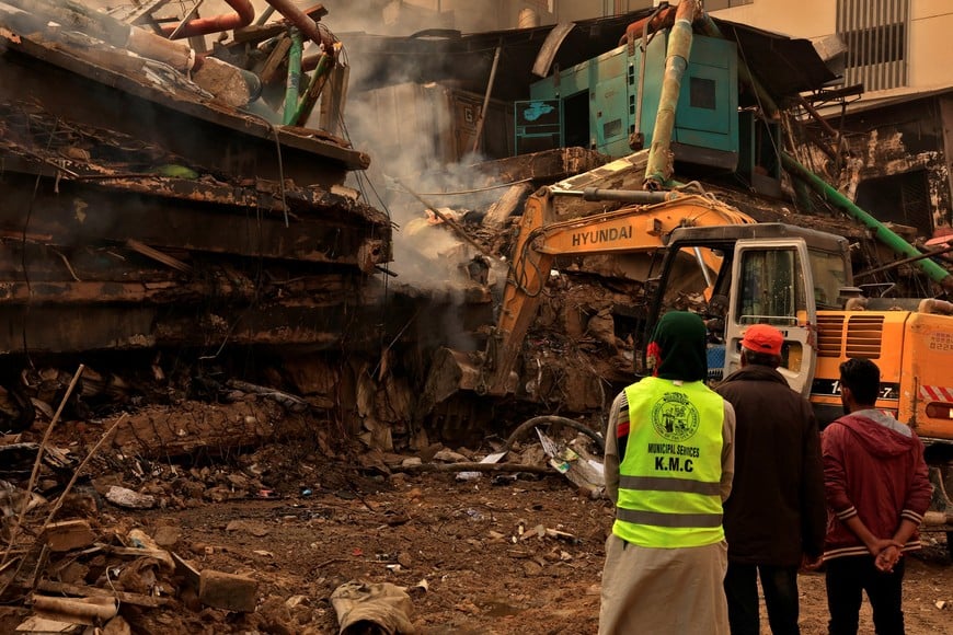 An earthmover removes debris following a massive fire that broke out in the Gul Plaza Shopping Centre in Karachi, Pakistan, January 19, 2026. REUTERS/Akhtar Soomro