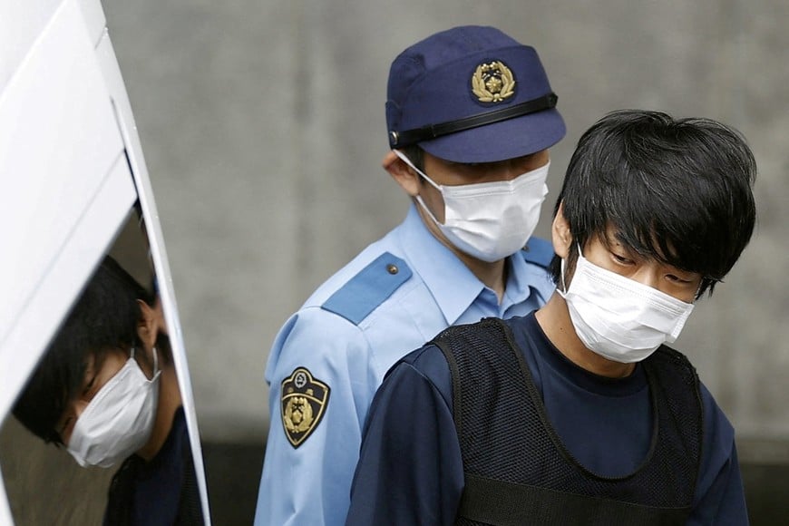 Tetsuya Yamagami, a suspected of killing former Japanese Prime Minister Shinzo Abe, is escorted by a police officer as he is taken to prosecutors, at Nara-nishi police station in Nara, western Japan, in this photo taken by Kyodo July 10, 2022. Mandatory credit Kyodo via REUTERS ATTENTION EDITORS - THIS IMAGE WAS PROVIDED BY A THIRD PARTY. MANDATORY CREDIT. JAPAN OUT. NO COMMERCIAL OR EDITORIAL SALES IN JAPAN.     TPX IMAGES OF THE DAY