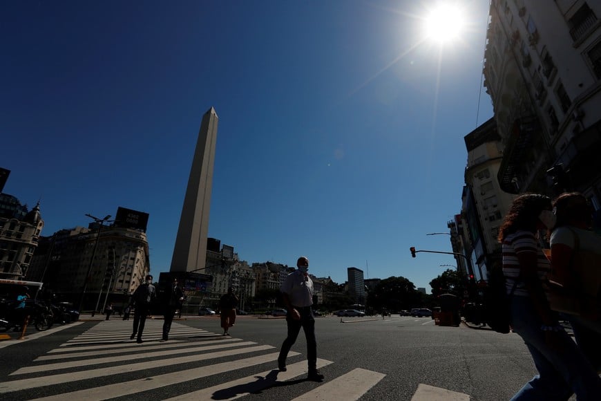Pedestrians walk past the Buenos Aires' Obelisk, Argentina April 6, 2021. Picture taken April 6, 2021. REUTERS/Agustin Marcarian