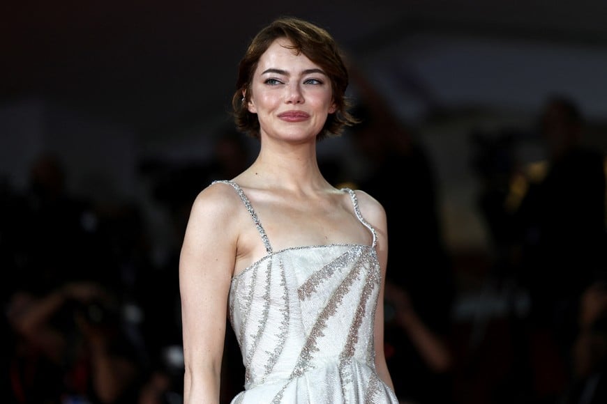 Cast member Emma Stone poses on the red carpet for the screening of the movie "Bugonia" in competition, at the 82nd Venice Film Festival, in Venice, Italy, August 28, 2025. REUTERS/Yara Nardi