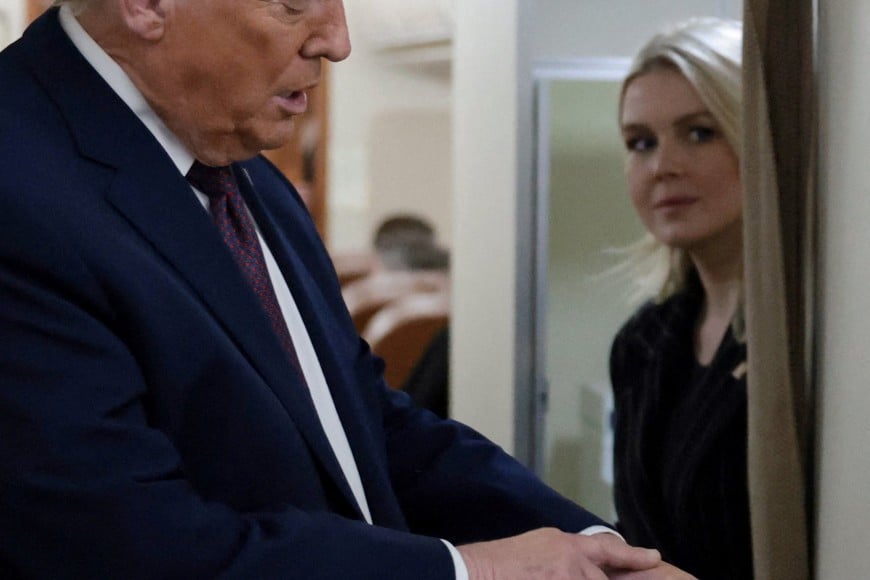 U.S. President Donald Trump speaks to reporters about a bruise on his left hand as he returns to Washington from the World Economic Forum (WEF) in Davos, Switzerland, aboard Air Force One, January 22, 2026. REUTERS/Jonathan Ernst