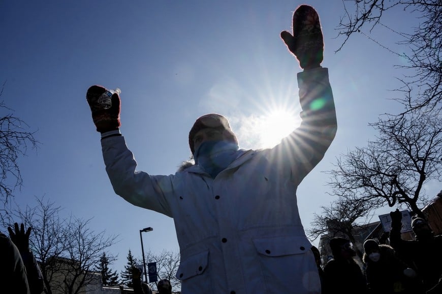 A person gestures as community members gather at the scene where federal agents fatally shot a man while trying to detain him, in Minneapolis, Minnesota, U.S., January 24, 2026. REUTERS/Tim Evans