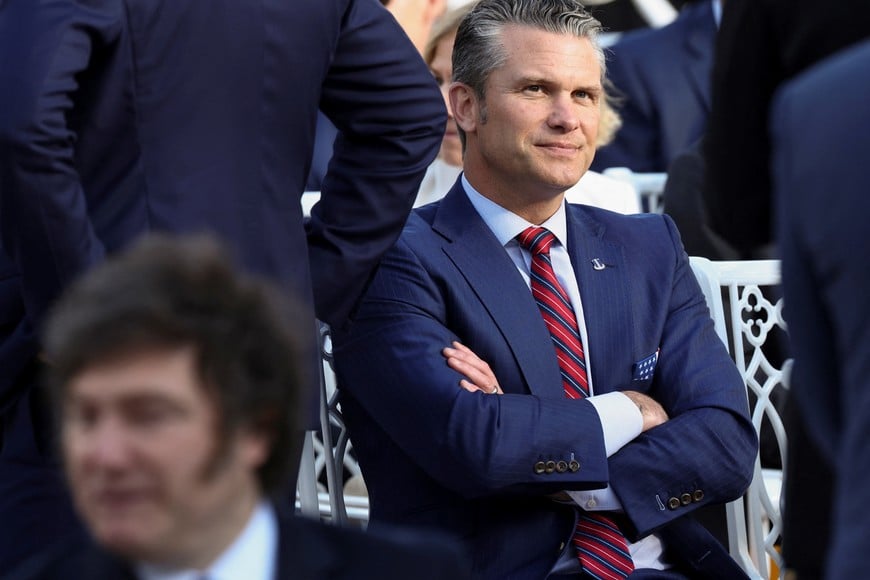 U.S. Defense Secretary Pete Hegseth sits near Argentina’s President Javier Milei as they attend a ceremony held by U.S. President Donald Trump to posthumously award the Medal of Freedom to Charlie Kirk in the Rose Garden at the White House in Washington, D.C., U.S., October 14, 2025. REUTERS/Kevin Lamarque