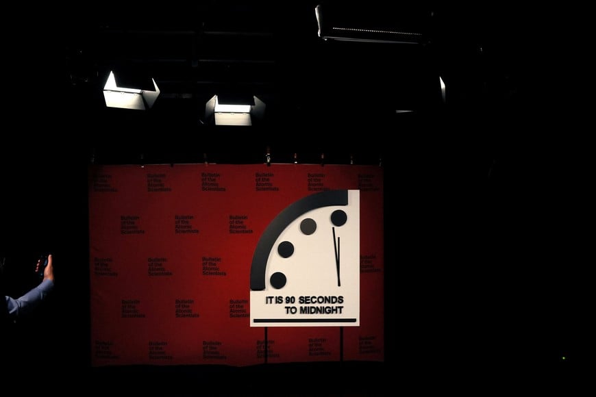 A participant records the clock with the Bulletin of the Atomic Scientists ahead of the announcement of the location of the minute hand on its Doomsday Clock, indicating what world developments mean for the perceived likelihood of nuclear catastrophe, at the National Press Club in Washington, U.S., January 24, 2023. REUTERS/Leah Millis
