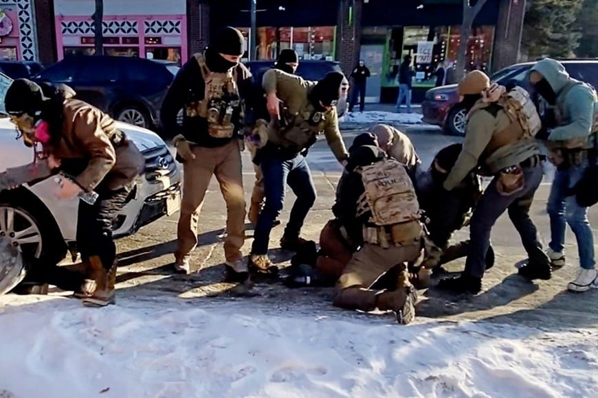 The moment that the firearm of a man identified as Alex Pretti is retrieved from a waistband holster by a federal officer (in light grey jacket, crouched) as another officer (in green) draws his weapon, before Pretti was fatally shot in Minneapolis, Minnesota, U.S., January 24, 2026 is seen in a still image of a video obtained by Reuters. VIDEO OBTAINED BY REUTERS/via REUTERS  THIS IMAGE HAS BEEN SUPPLIED BY A THIRD PARTY. NO RESALES. NO ARCHIVES. AN UNCROPPED AND UNPROCESSED VERSION HAS BEEN PROVIDED SEPARATELY. 

VERIFICATION LINES:
Reuters was able to verify the location and date of the videos from original file metadata. Buildings, road layout, trees and utility poles which matched file and satellite imagery of the place. The Department of Homeland Security said one of his agents fired shots in Minneapolis, Minnesota on Saturday (January 24). Minnesota Governor Tim Walz confirmed a shooting by federal agents took place on Saturday (January 24).