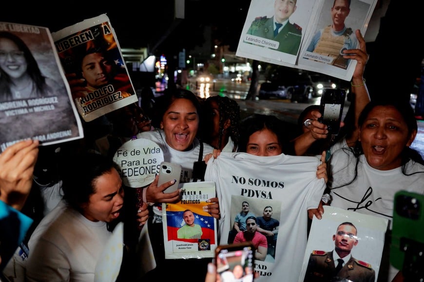 Relatives of detainees react to an announcement on a phone after Venezuela’s interim president Delcy Rodriguez announced a proposed "amnesty law" for hundreds of prisoners, outside the Helicoide detention centre, in Caracas, Venezuela, January 30, 2026. REUTERS/Gaby Oraa