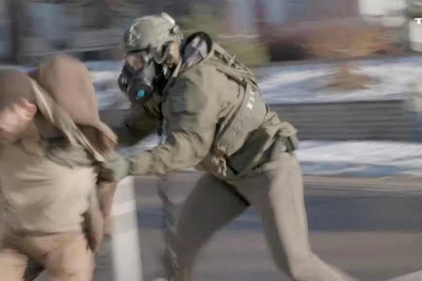 A U.S. Immigration and Customs Enforcement (ICE) agent tries to detain Alex Pretti, days before he was fatally shot, in this screengrab obtained from a video, in Minneapolis, Minnesota, U.S., January 13, 2026. The News Movement/via REUTERS  THIS IMAGE HAS BEEN SUPPLIED BY A THIRD PARTY. MANDATORY CREDIT. MUST NOT OBSCURE LOGO.

VERIFICATION:
Reuters confirmed that the man confronting agents in the vehicle is Alex Pretti from his height, facial features and clothing which matched verified videos from several days later when he was killed, and file imagery. The equipment of the men in the vehicle matched gear worn by ICE agents in Minneapolis. The location where the video was filmed has been verified from the buildings, traffic lights, pedestrian crossing, road layout and fences which matched file and satellite imagery of the area. The sequence of events in the video matched corroborating visuals from the scene. The date when the video was filmed has been verified by the media reports of