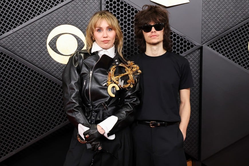 Miley Cyrus and Maxx Morando pose at the red carpet during the 68th Annual Grammy Awards in Los Angeles, California, U.S., February 1, 2026. REUTERS/Mario Anzuoni