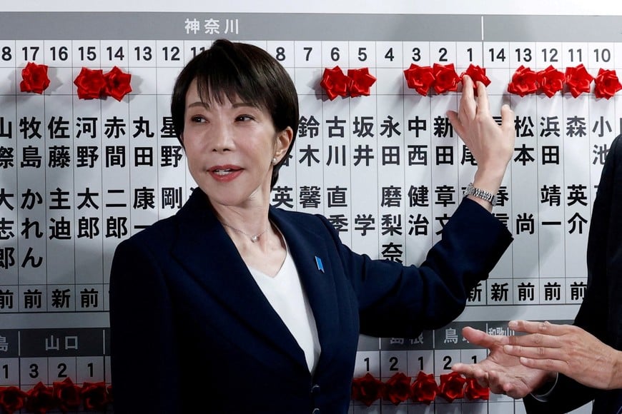 Japan's Prime Minister Sanae Takaichi, leader of the ruling Liberal Democratic Party (LDP), places a red paper rose on the name of an elected candidate at the LDP headquarters on general election day in Tokyo, Japan, February 8, 2026. REUTERS/Kim Kyung-Hoon/Pool     TPX IMAGES OF THE DAY