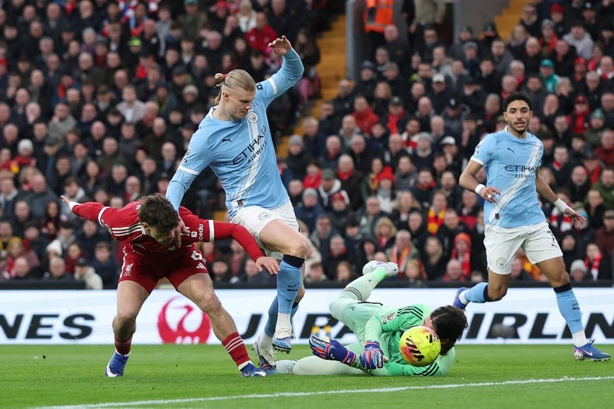Soccer Football - Premier League - Liverpool v Manchester City - Anfield, Liverpool, Britain - February 8, 2026
Liverpool's Milos Kerkez and Alisson Becker in action with Manchester City's Erling Haaland REUTERS/Phil Noble EDITORIAL USE ONLY. NO USE WITH UNAUTHORIZED AUDIO, VIDEO, DATA, FIXTURE LISTS, CLUB/LEAGUE LOGOS OR 'LIVE' SERVICES. ONLINE IN-MATCH USE LIMITED TO 120 IMAGES, NO VIDEO EMULATION. NO USE IN BETTING, GAMES OR SINGLE CLUB/LEAGUE/PLAYER PUBLICATIONS. PLEASE CONTACT YOUR ACCOUNT REPRESENTATIVE FOR FURTHER DETAILS..