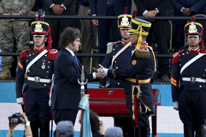 Argentina's President Javier Milei holds the curved sabre that belonged to Argentina's independence leader General Jose de San Martin, during a ceremony to present it to the San Lorenzo regiment, in San Lorenzo, Santa Fe, Argentina, February 7, 2026. REUTERS/Francisco Loureiro