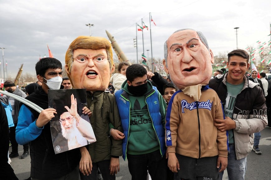 Attendees wear masks depicting U.S. President Donald Trump and Israeli Prime Minister Benjamin Netanyahu, during the 47th anniversary of the Islamic Revolution in Tehran, Iran February 11, 2026. Majid Asgaripour/WANA (West Asia News Agency) via REUTERS ATTENTION EDITORS - THIS PICTURE WAS PROVIDED BY A THIRD PARTY     TPX IMAGES OF THE DAY