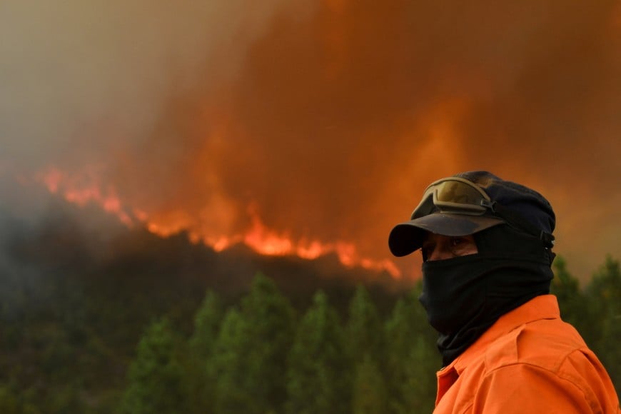 FILE PHOTO: A civil protection member looks on near an area affected by wildfires in Cholila, in the Patagonian province of Chubut, Argentina, February 1, 2026. REUTERS/Nicolas Palacios/File Photo