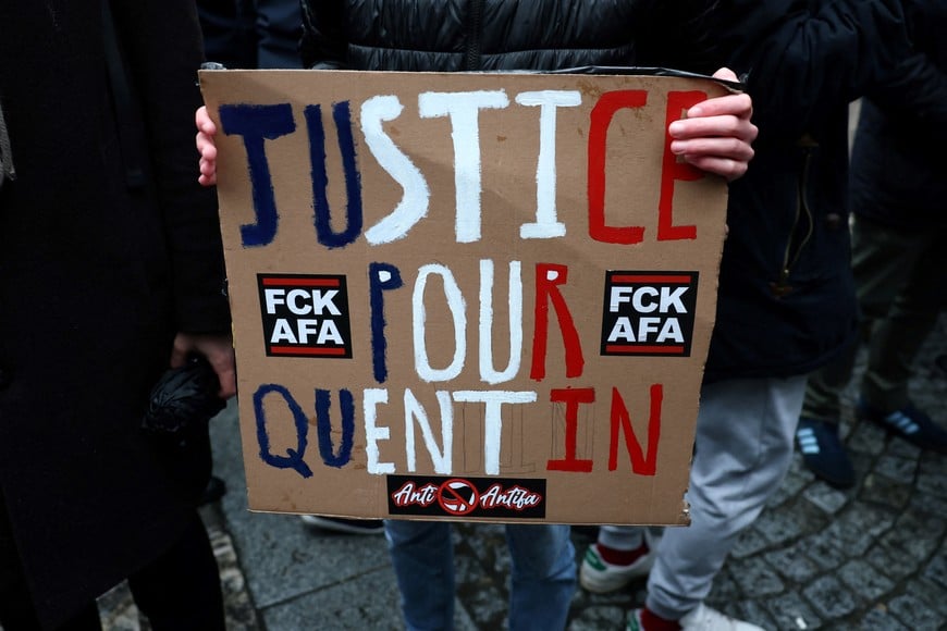 A person holds a sign as people gather to pay tribute to Quentin, an activist who died from injuries sustained during a beating on February 12 in Lyon, during a demonstration at the Place de la Sorbonne in Paris, France, February 15, 2026. REUTERS/Stephane Mahe